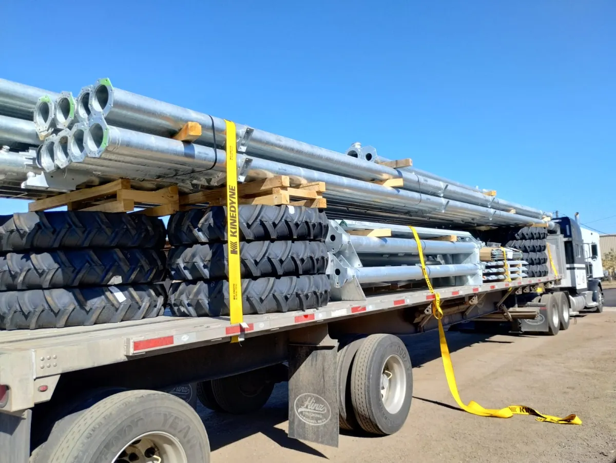 Flatbed loaded with galvanized steel and machinery components